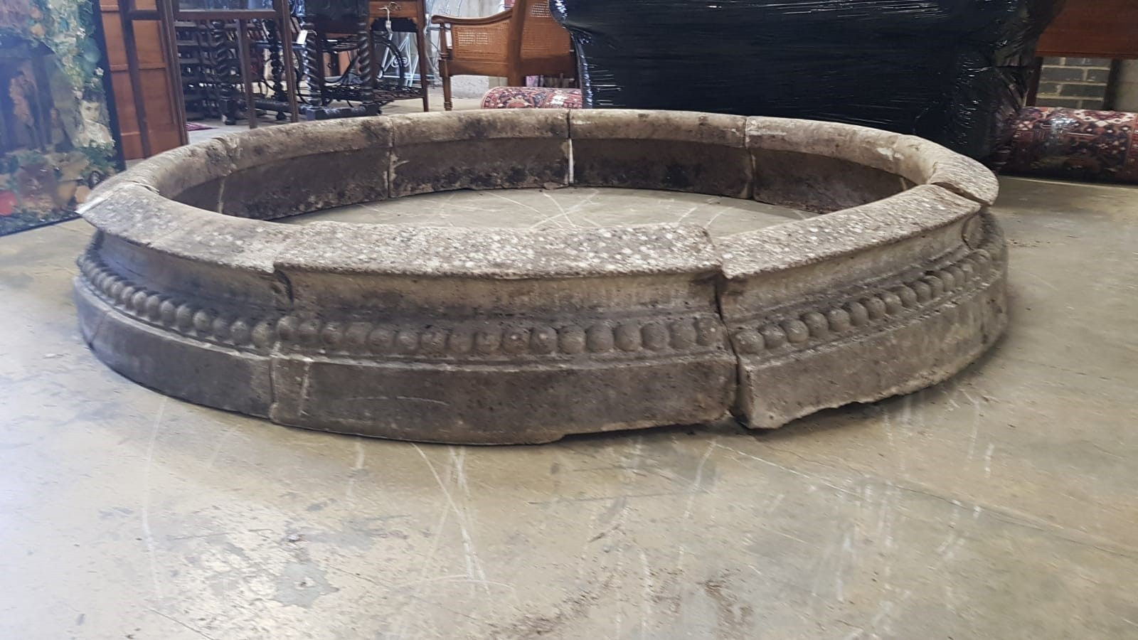 A reconstituted stone circular sectional garden planter, each segment width 68cm, height 28cm